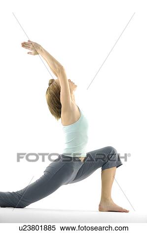 Stock Photography - Side profile of a young woman practicing yoga. Fotosearch