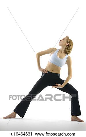 Young woman practicing yoga View Large Photo Image Stock Image - Young woman practicing yoga. Fotosearch