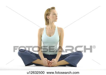 Stock Image - Young woman sitting in a cobbler pose. Fotosearch