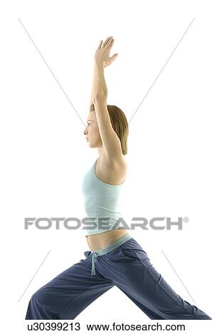 Young woman standing in warrior position View Large Photo Image Stock Image - Young woman standing in warrior position. Fotosearch