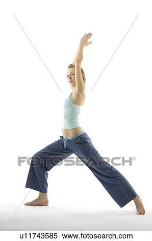 Young woman standing in warrior position View Large Photo Image Stock Photography - Young woman standing in warrior position. Fotosearch