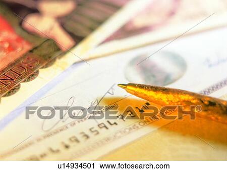 Stock Image - indoor, money, cash, check, pen, business. Fotosearch