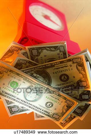 Stock Photo - indoor, money, cash, clock, light, shadow. Fotosearch