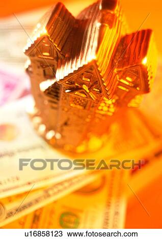 Stock Image - indoor, money, cash, light, shadow, gold. Fotosearch