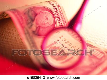 Stock Image - indoor, money, cash, magnifying glass. Fotosearch