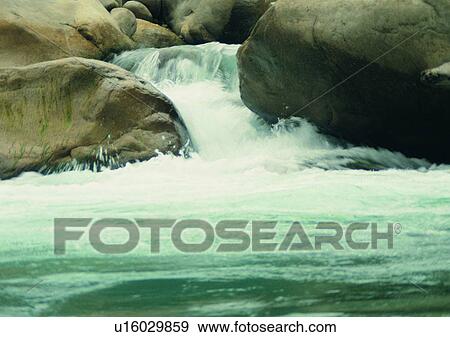 Stock Photo - waterfall, cloud, nature, mountain, rock, sky. Fotosearch