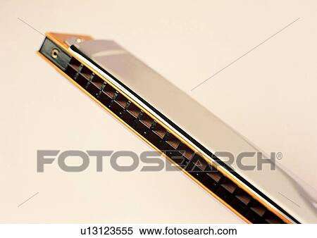 Music, Wind Instrument, Entertainment, Colored Background, Shiny, Harmonica View Large Photo Image Stock Photography - Music, Wind Instrument, Entertainment, Colored Background, Shiny, Harmonica. Fotosearch