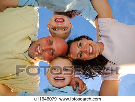 Stock Photo - Low angle view of a family in a huddle. Fotosearch