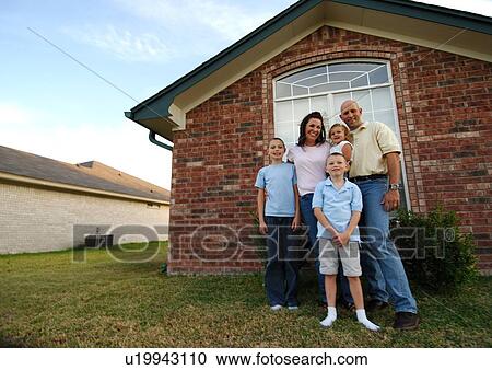 Portrait of a mid adult couple standing with their three children and smiling View Large Photo Image Stock Image - Portrait of a mid adult couple standing with their three children and smiling. Fotosearch