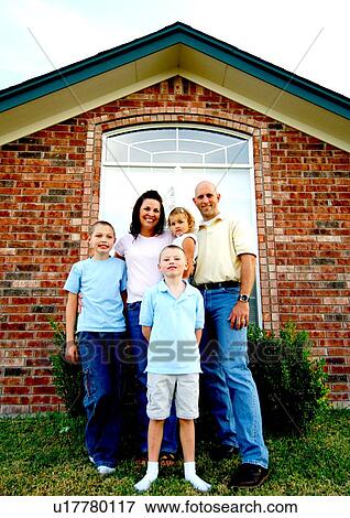 Portrait of a mid adult couple standing with their three children and smiling View Large Photo Image Stock Photo - Portrait of a mid adult couple standing with their three children and smiling. Fotosearch