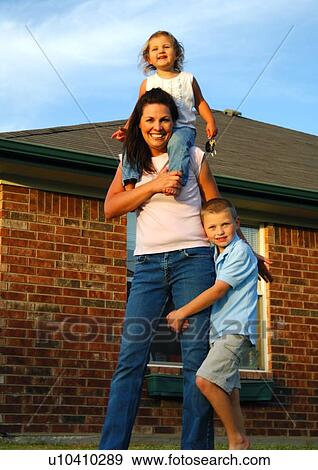 Portrait of a mid adult woman smiling with her son and daughter View Large Photo Image Stock Photo - Portrait of a mid adult woman smiling with her son and daughter. Fotosearch