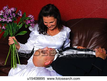 Close-up of a mid adult couple on a couch View Large Photo Image Stock Photography - Close-up of a mid adult couple on a couch. Fotosearch