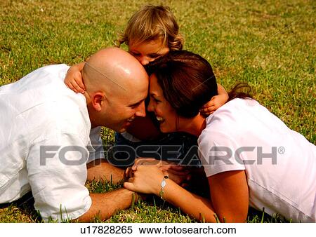 Girl whispering into his parent's ear View Large Photo Image Stock Photography - Girl whispering into his parent's ear. Fotosearch