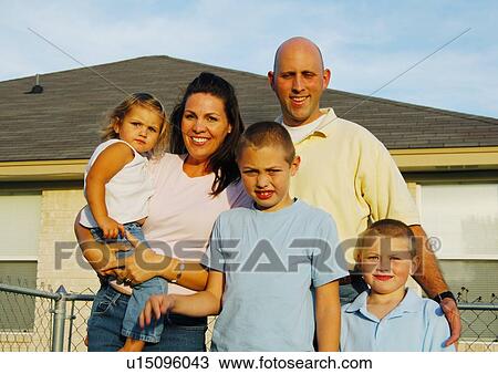 Mid adult couple standing with their children View Large Photo Image Stock Image - Mid adult couple standing with their children. Fotosearch
