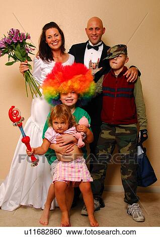 Stock Image - Portrait of a mid adult couple with their children. Fotosearch