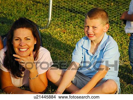 Picture - Portrait of a mid adult woman with her son in a park. Fotosearch