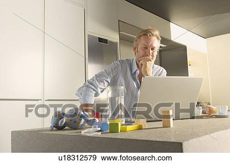 Stock Photo - Businessman working from home.. Fotosearch