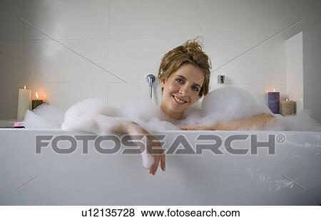 Woman smiling in bathtub View Large Photo Image Stock Photo - Woman smiling in bathtub. Fotosearch