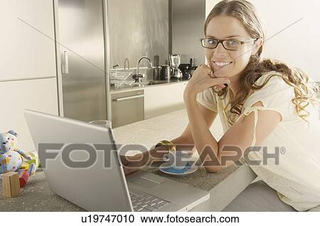Young business woman working from home kitchen. View Large Photo Image Stock Image - Young business woman working from home kitchen.. Fotosearch