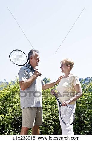 Couple with tennis rackets View Large Photo Image Stock Photo - Couple with tennis rackets. Fotosearch