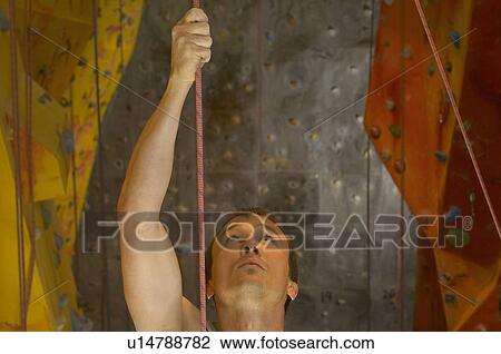 Man holding onto rope at indoor climbing centre, close-up View Large Photo Image Stock Image - Man holding onto rope at indoor climbing centre, close-up. Fotosearch