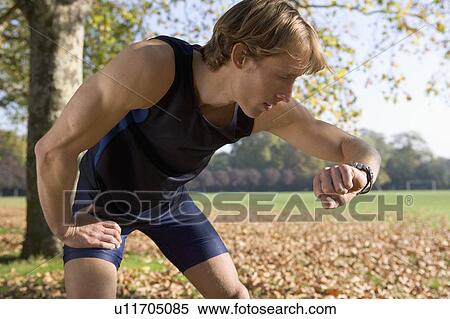 Stock Photography - Runner checking his watch.. Fotosearch