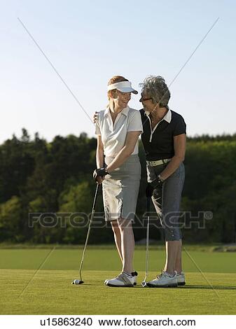 Two women on golf green View Large Photo Image Stock Image - Two women on golf green. Fotosearch