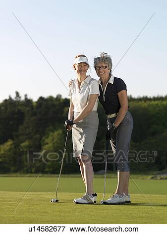 Stock Photo - Two women on golf green. Fotosearch