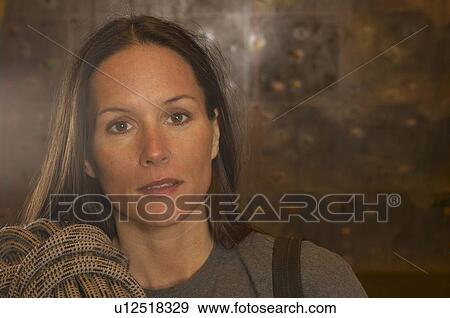 Stock Photo - Woman at indoor climbing centre, portrait. Fotosearch
