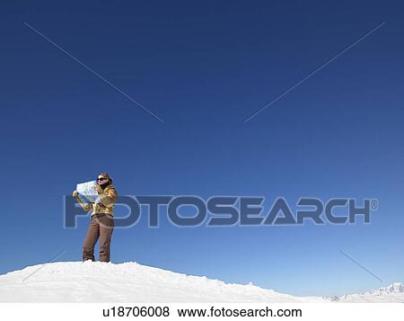 Young woman looking at map View Large Photo Image Stock Photo - Young woman looking at map. Fotosearch