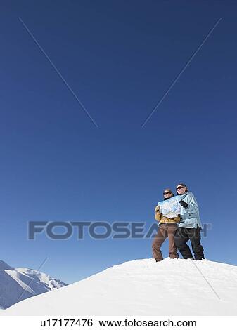 Stock Photograph - Young women looking at map. Fotosearch