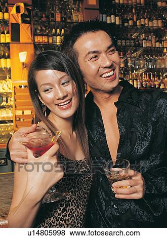 Stock Photo - Arm Around, Bar Counter, Bar, Asian Ethnicity, Affectionate. Fotosearch