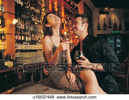 Stock Photo - Arm Around, Bar Counter, Bar, Asian Ethnicity, Amused. Fotosearch