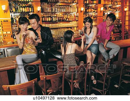 Asian Ethnicity, Beer Bottle, Bar Counter, Bar, Amused View Large Photo Image Stock Photo - Asian Ethnicity, Beer Bottle, Bar Counter, Bar, Amused. Fotosearch