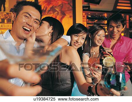Stock Photography - Asian Ethnicity, Black Hair, Bar, Bangs, Arm Around. Fotosearch
