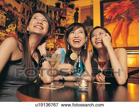 Stock Photo - Asian Ethnicity, Bracelet, Bar, Bangs, Amused. Fotosearch