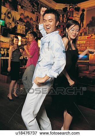 Asian Ethnicity, Brown Hair, Bar, Back To Back, Amused View Large Photo Image Stock Photo - Asian Ethnicity, Brown Hair, Bar, Back To Back, Amused. Fotosearch