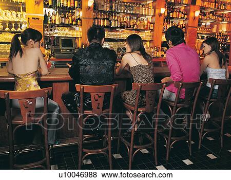 Stock Photo - Bar, Brown Hair, Beer Bottle, Bar Counter, Asian Ethnicity. Fotosearch