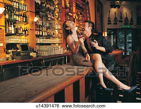 Casual Clothing, Standing, Bar Counter, Young Women, Two People, Young Couple, Rolled Up Sleeves View Large Photo Image Stock Photograph - Casual Clothing, Standing, Bar Counter, Young Women, Two People, Young Couple, Rolled Up Sleeves. Fotosearch