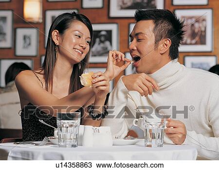 Stock Image - Focus On Foreground, T-Shirt, Sitting, Table For Two, Youth Culture, Plate. Fotosearch