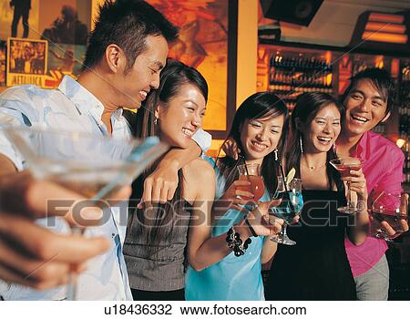 Stock Image - Group Of People, Button Down Shirt, Bangs, Enjoyment, Leisure Activity. Fotosearch