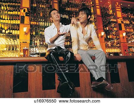 Stock Image - Looking Up, Leisure Activity, Sitting, Casual Clothing, Beer, Asian. Fotosearch