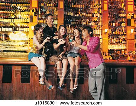 Togetherness, Young Women, Asian Ethnicity, Mouth Open, Laughing, Sitting, Skirt View Large Photo Image Stock Image - Togetherness, Young Women, Asian Ethnicity, Mouth Open, Laughing, Sitting, Skirt. Fotosearch