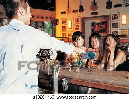 Stock Photograph - Youth Culture, Cheerful, Side By Side, Rolled Up Sleeves, Brown Hair, Hair Back, Amused. Fotosearch