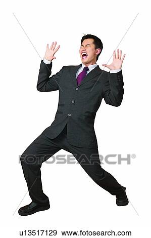 Stock Photo - Businessman, Asian Ethnicity, Business Suit, Black Hair, Bending, Arms Raised. Fotosearch