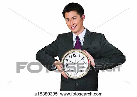 Cheerful, Asian Ethnicity, Businessman, Clock, Seconds Hand, Toothy Smile View Large Photo Image Stock Photography - Cheerful, Asian Ethnicity, Businessman, Clock, Seconds Hand, Toothy Smile. Fotosearch