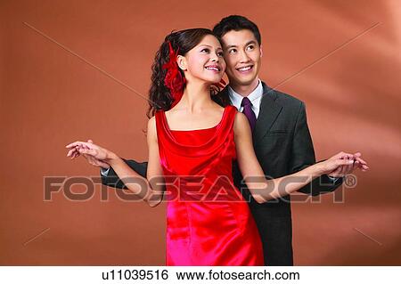 Stock Photograph - Affectionate, Black Hair, Asian Ethnicity, Arm Outstretched, Adults Only. Fotosearch