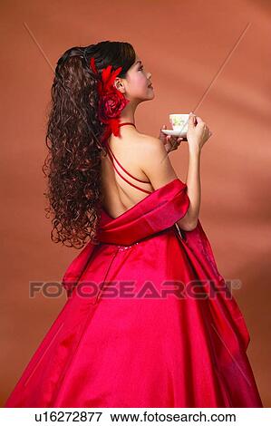 Stock Photo - Black Hair, Cup, Colored Background, Asian Ethnicity. Fotosearch