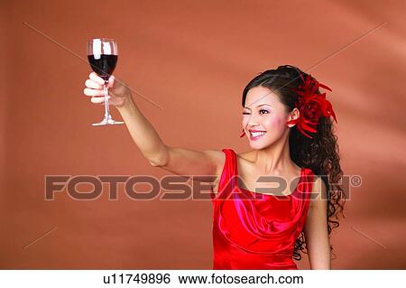 Stock Photograph - Colored Background, Happiness, Alcohol, Fashion, Waist-Up, Young Adult. Fotosearch