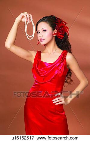 Evening Gown, Indoor, Posing, One Young Woman Only, Evening Wear, Holding, Beautiful View Large Photo Image Stock Photo - Evening Gown, Indoor, Posing, One Young Woman Only, Evening Wear, Holding, Beautiful. Fotosearch